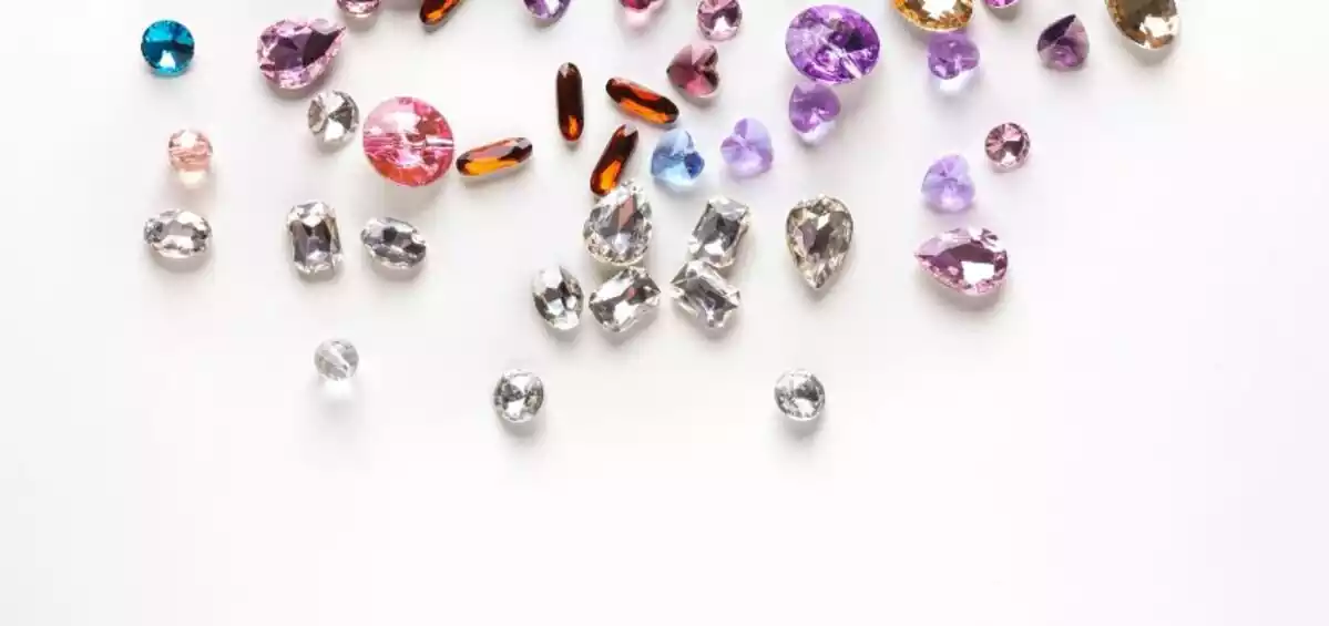 Gemstones of different colors and sizes on white background